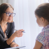 young girl talking with child psychiatrist